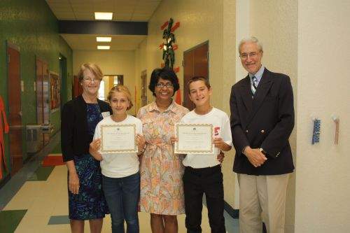 Noreen Fisher, President of The Library Foundation presented certificates and a gift to Young Literary Leaders Alyssa Busch and Lawrence Tatum at Citrus Gove Elementary School with program sponsor Arati Hammond, Realtor® of RE/MAX of Stuart and Dennis Fruitt, Executive Director.